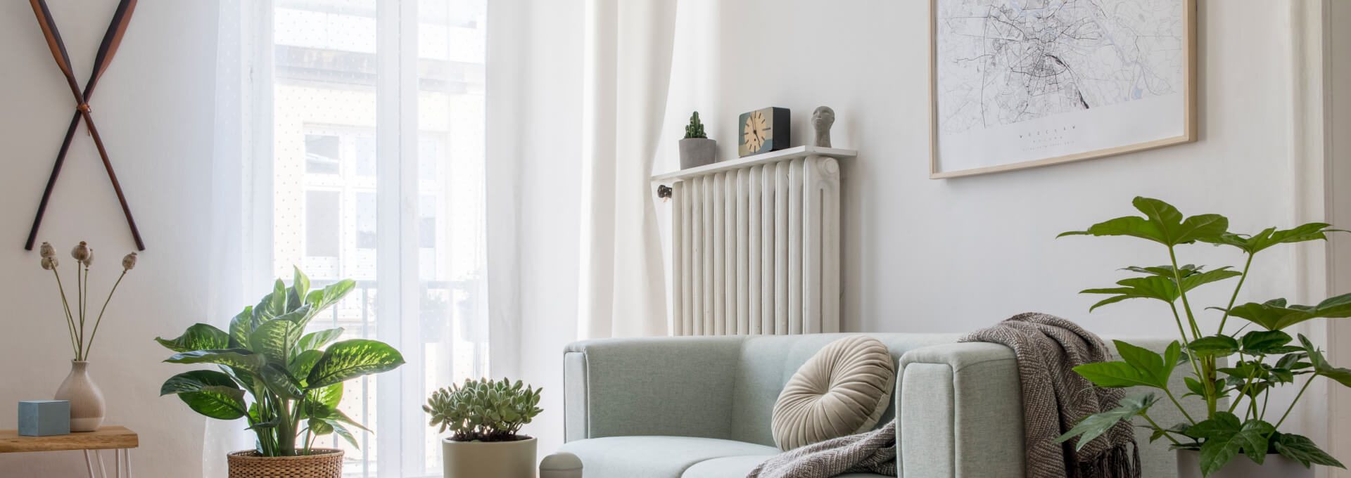 a living room with a couch, coffee table and plants at The The Huxley