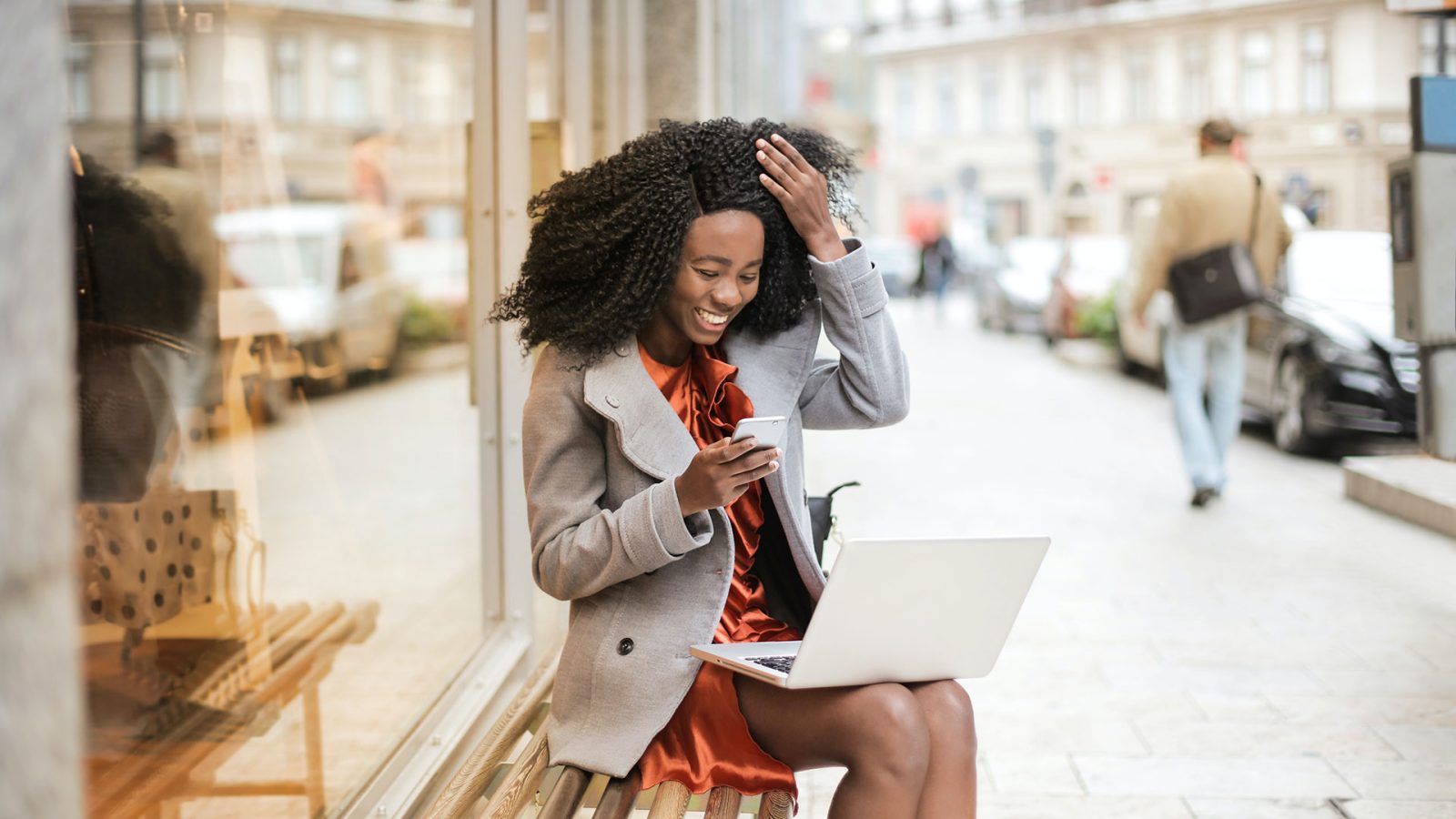 a woman sitting on a bench with her laptop at The The Huxley