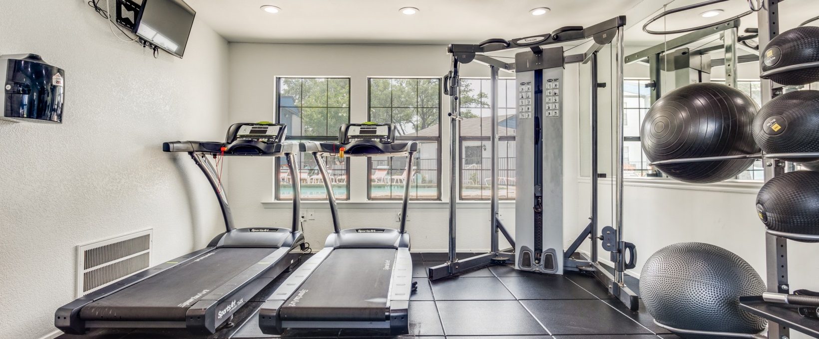 a gym room with treadmills and exercise equipment at The The Huxley