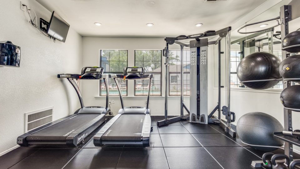 a gym room with treadmills and exercise equipment at The The Huxley