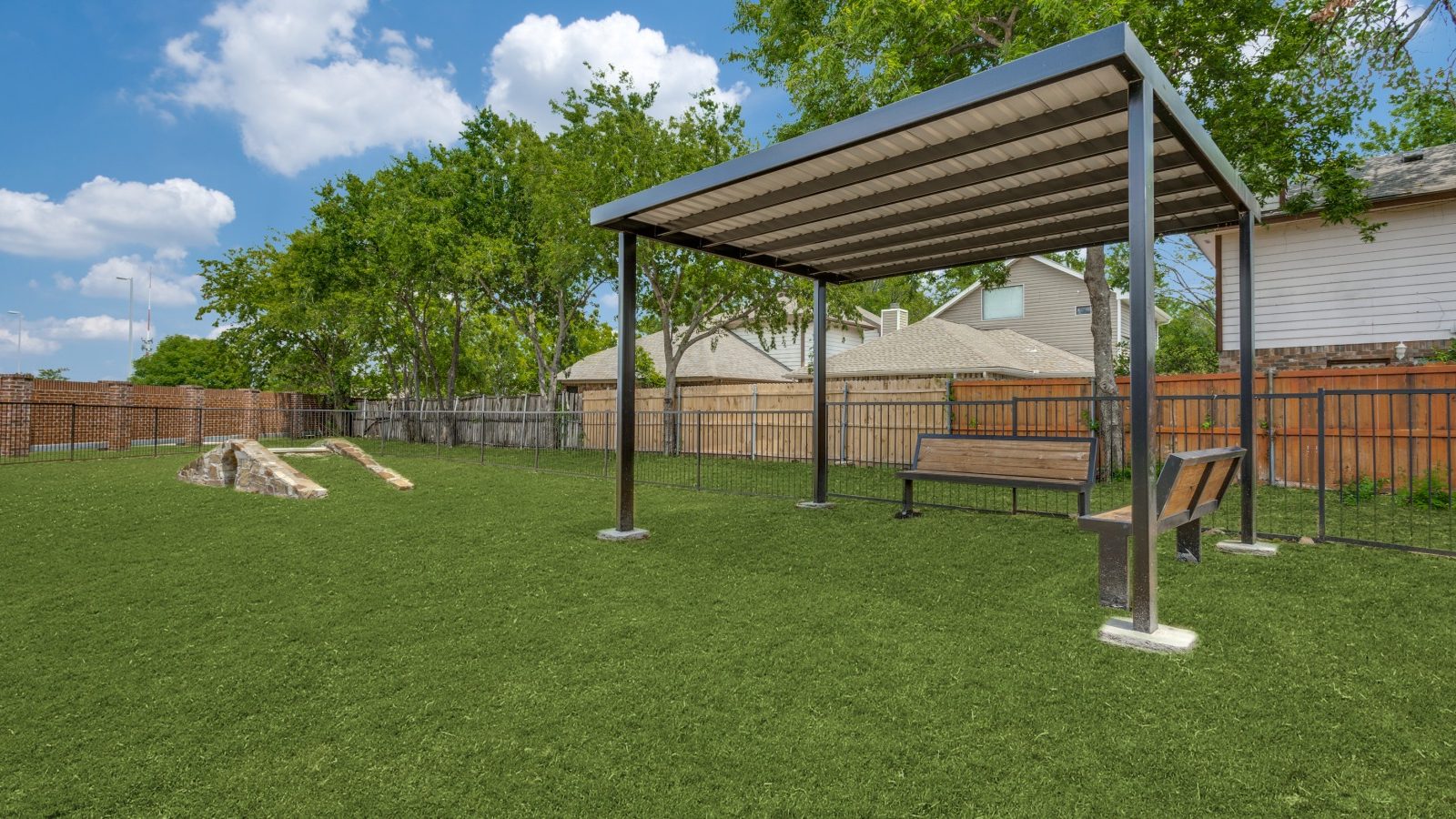 a backyard with a covered gazebo and a dog park at The The Huxley