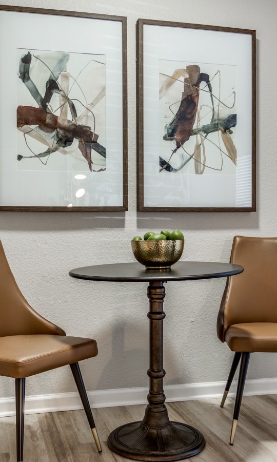 a dining room with two chairs and a table at The The Huxley