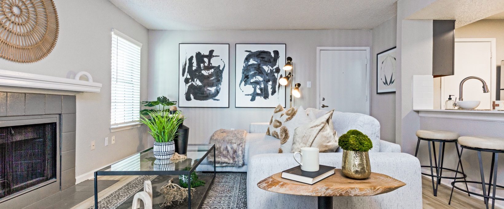 a living room with a fireplace and a couch at The The Huxley