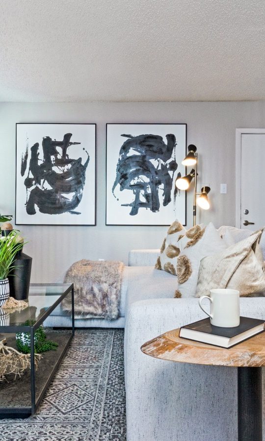 a living room with a fireplace and a couch at The The Huxley