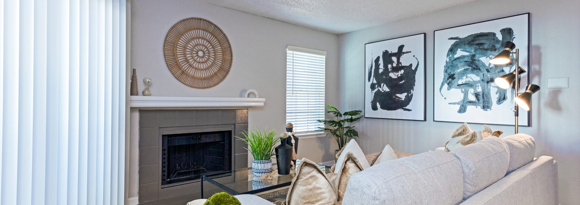 a living room with white furniture and a fireplace at The The Huxley