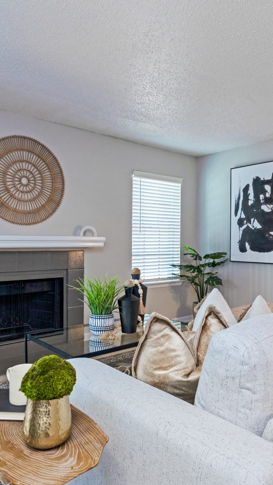 a living room with white furniture and a fireplace at The The Huxley